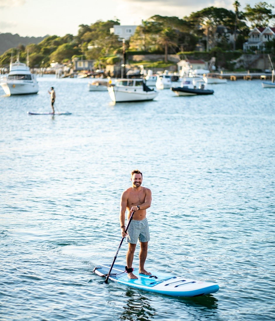 Red Paddle Co Stand up paddle shop man paddling river 940x1100