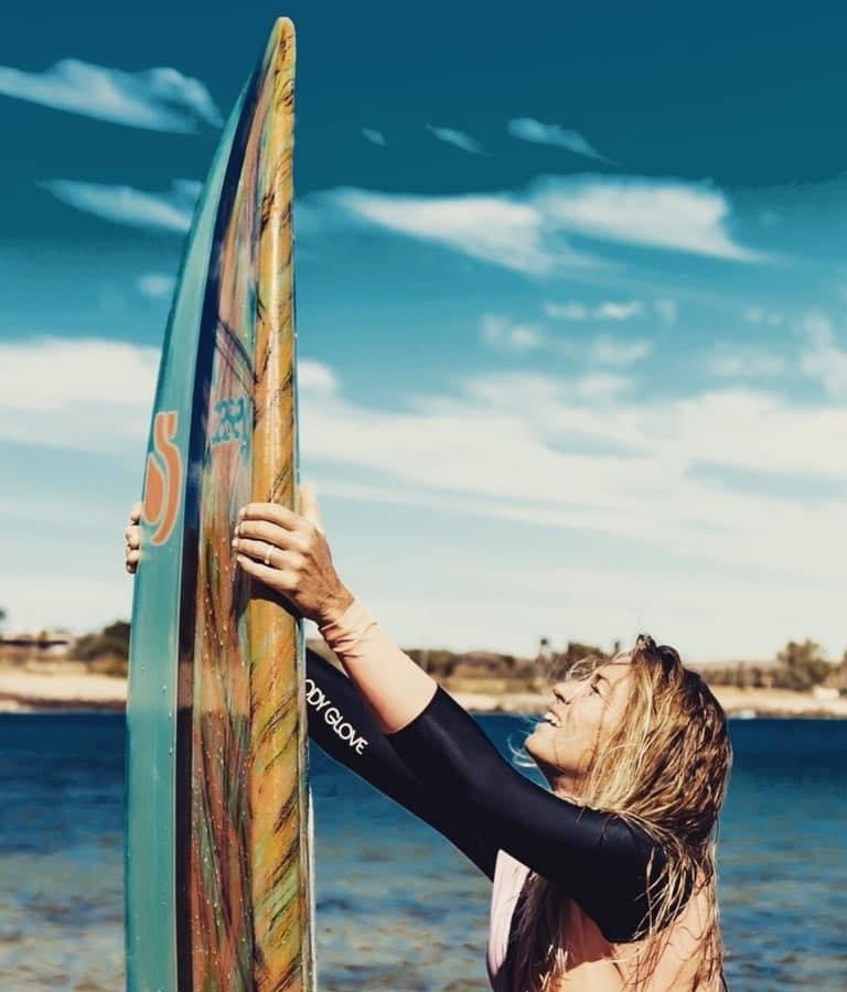 Stand Up Surf Shop SUP girl woman looking at board 770x900