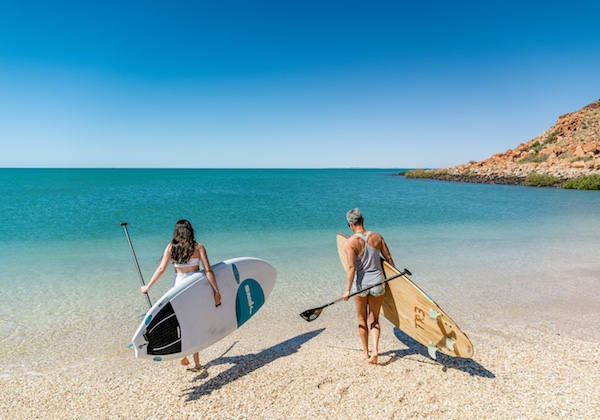 stand up surf shop private sup lessons perth sup school coaching women carrying boards