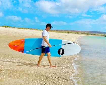 stand-up-surf-shop-stand-up-paddle-boards-sup-foil-free-demos-man-walking-into-water-north